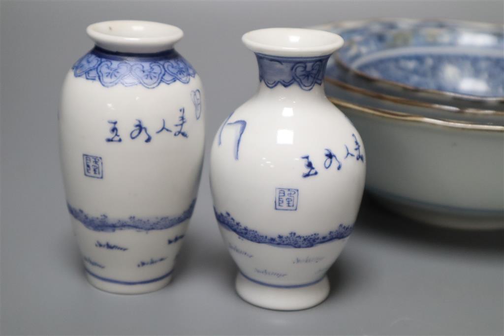 A graduated set of three Chinese porcelain blue and white bowls, largest 19cm and a group of four miniature Chinese blue and white vase